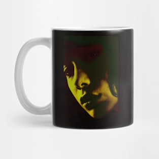 Beautiful girl face in dark lighting. Yellow green light, red tones. Dark and beautiful. Mug